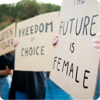 Activists holding Freedom of Choice and The Future is Female protest signs